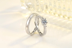Macro detail of a six-prong moissanite engagement ring set with adjustable bands