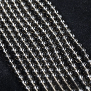 Macro shot of high-quality polished dark grey glass beads for DIY jewelry making