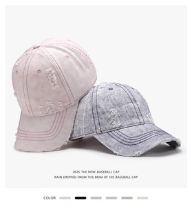 Detail of distressed vintage cotton baseball caps with worn-out texture and ripped edges