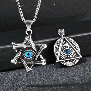 Macro detail of silver gothic pendants featuring Hexagram and All-Seeing Eye with blue eyes