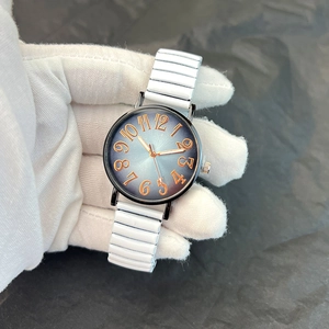 Detailed macro view of an elastic metal watch band with a gradient blue sunray dial