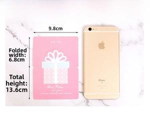 Size comparison of a pink folding heart card next to a smartphone showing dimensions