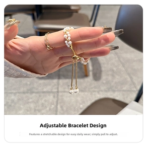 Detail of double-layer pearl bracelet with adjustable golden slider clasp on wrist