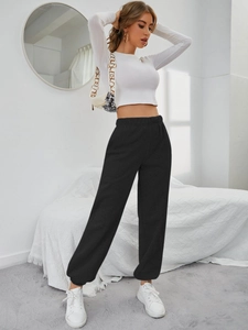 Vista a figura intera di pantaloni sportivi neri a vita alta con crop top bianco moderno