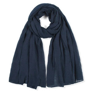 Deep blue crinkle cotton linen scarf with elegant drape texture on white background