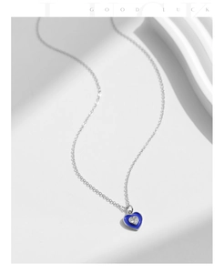 Close-up of S925 silver heart necklace with blue enamel and sparkling zircon stone