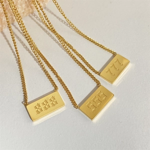 Macro shot of 18K gold plated square pendants engraved with lucky numbers 888, 555, and 777