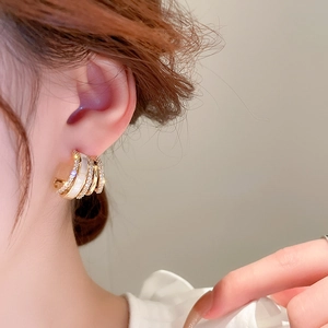 Chic gold layered geometric hoop earrings with micro-inlaid diamonds and white inlay detail