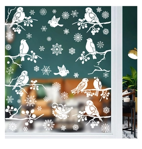 Detail view of festive white Christmas window decals with snow birds and berry branches