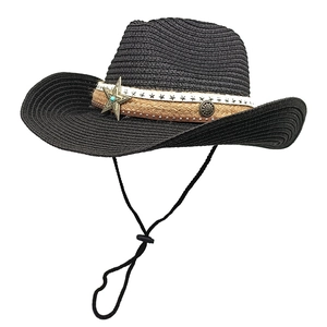 Detail of black straw cowboy hat featuring star prints and vintage metal accents