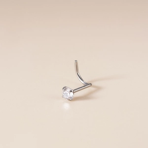 Titanium nose stud with a clear cubic zirconia stone in a 4-prong setting with curved bar
