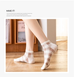 Detail of breathable brown and white checkered pattern cotton socks with ribbed ankle cuff