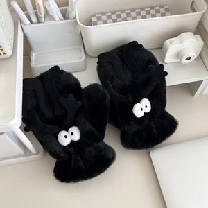 Detailed view of cute black plush mittens with funny reindeer antlers and googly eyes