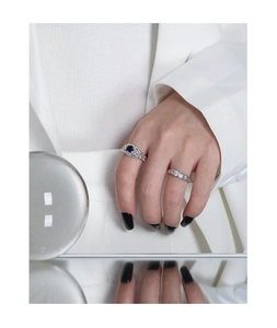 Close-up of S925 silver rings with blue gemstone and pavé zircon on model hand