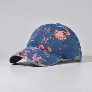 Close-up of denim baseball cap with vibrant tropical floral pattern and curved brim detail
