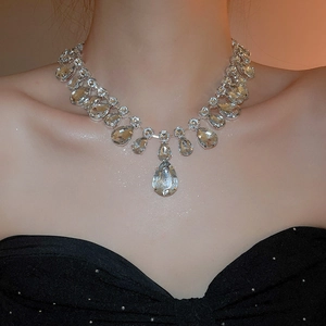 Close-up of luxury silver-toned necklace featuring tiered water drop crystal pendants