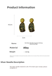 Detail view of vintage black and gold enamel earrings with 925 silver needles and striped pattern