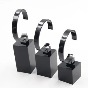 Three-piece black acrylic watch display stand set in various heights for jewelry showcasing
