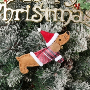 Detailed view of felt dachshund dog Christmas tree ornament with Santa hat and sweater