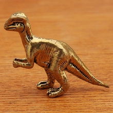 Detailed side view of a realistic brass velociraptor figurine on a wooden background