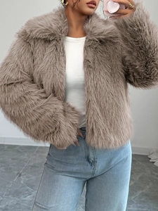 Detail of taupe faux fur coat featuring a zipper closure and elegant wide lapels
