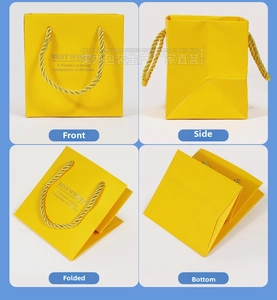 Macro view of bright yellow jewelry gift bag with golden rope handles and Best Wishes text