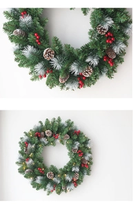 Detailed close-up of Christmas wreath with frosted pine needles, red berries and warm LED lights
