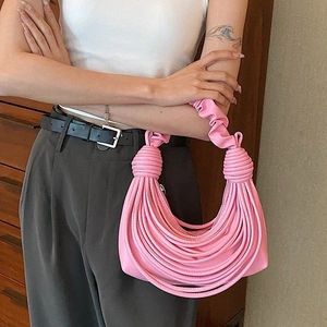 Pink pleated crossbody bag with creative fringe detail and stylish knotted handle