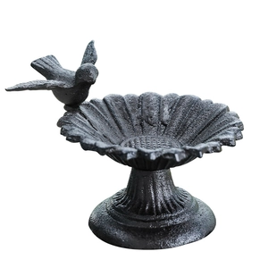 Antique black cast iron sunflower bird feeder with standing bird statue and vintage base