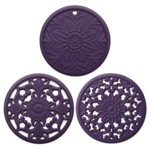 Three purple silicone heat-resistant mats with intricate hollowed-out mandala patterns