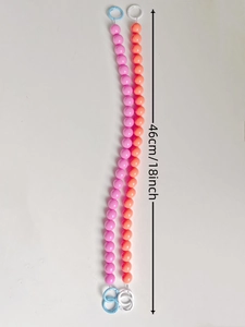 Detail of colorful plastic beaded tissue holder strap in pink and orange, 46cm long