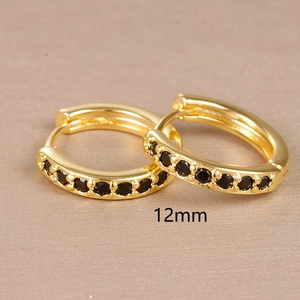 Detailed close-up of 12mm gold hoop earrings with small black zircon stones inlay