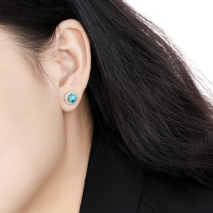 Elegant S925 sterling silver turquoise stud earrings with halo diamonds on female model
