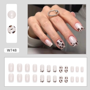 French leopard print press-on nails in creamy white with a short square shape and aurora finish