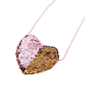 Detail of pink and gold sequin heart-shaped mini crossbody bag with a slim braided strap