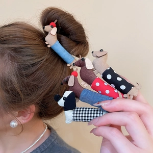 Detailed view of handmade dachshund fabric hair clips in polka dots and plaid patterns