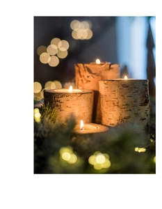Detail view of natural birch wood candle holders with tea lights and warm bokeh background
