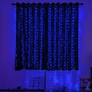 Detail of blue LED curtain lights hanging vertically on a dark curtain backdrop