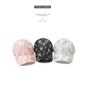 Detailed view of floral embroidery and metallic threads on lace baseball caps