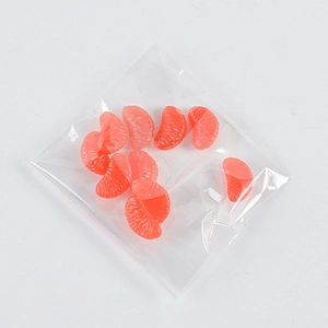 Macro view of realistic PVC miniature orange slices with detailed pulp texture in a clear bag
