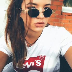 Detail of vintage steampunk sunglasses with gold metal frames and oval lenses for women