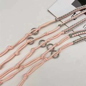 Detail of hand-woven pink and grey adjustable shoulder straps with silver metal rings
