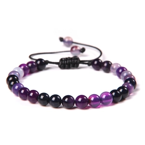 Adjustable woven beaded bracelet with 6mm purple and black stones on white background