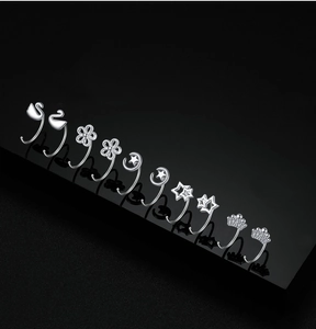Macro shot of various sterling silver stud earrings including swan and crown designs