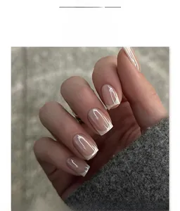 Detail of short square press-on nails with nude base and classic white French tips
