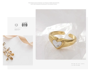Close-up of a gold heart shell ring with adjustable band and natural mother-of-pearl