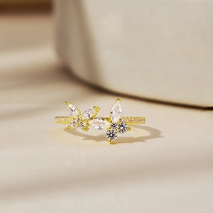Detailed macro view of gold butterfly ring with marquise and round cubic zirconia stones