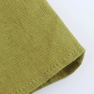 Macro shot of olive green linen fabric texture with neat stitching detail on the hem