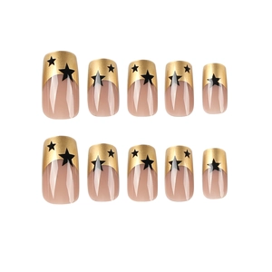 Golden French tip press-on nails with black stars and square-round shape on white background