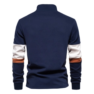Detail of navy blue polo sweatshirt featuring white and brown sleeve color-block design
